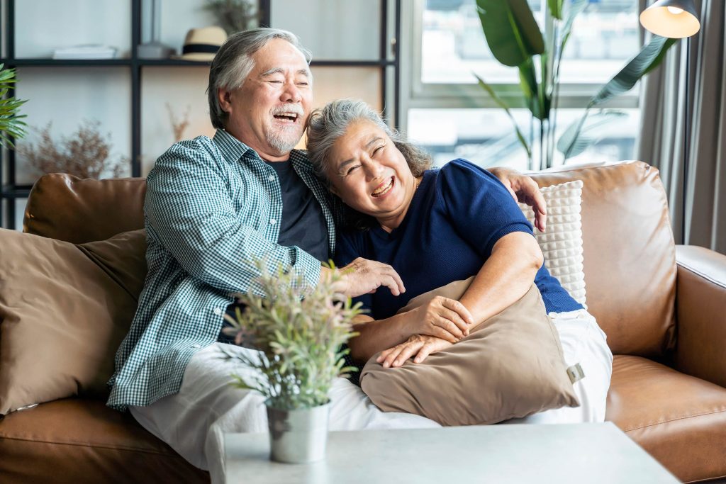 Asian couple relaxing on couch
